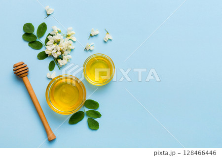 honey jar with acacia flowers and leaves. fresh honey top view flat lay honey jar with acacia flowers and leaves. fresh honey top view flat lay 128466446