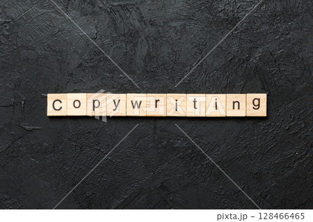 Copywriting word written on wood block. Copywriting text on cement table for your desing, concept 128466465