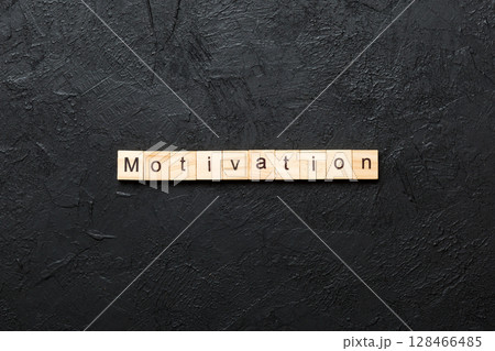 Motivation word written on wood block. Motivation text on cement table for your desing, concept 128466485
