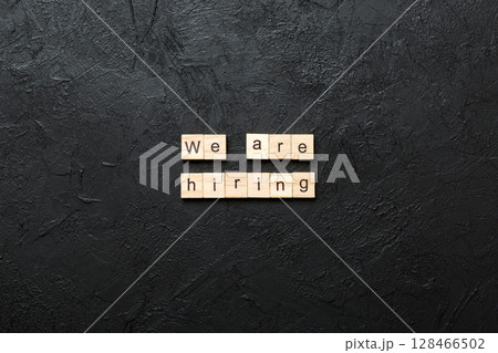 We are hiring word written on wood block. We are hiring text on cement table for your desing, Top view concept 128466502