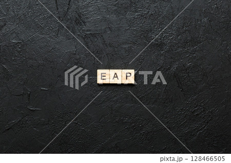 EAP word written on wood block. employee assistance program text on table, concept EAP word written on wood block. employee assistance program text on table, concept 128466505