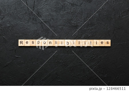 responsibility word written on wood block. responsibility text on table, concept 128466511