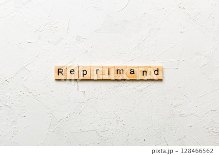 reprimand word written on wood block. reprimand text on table, concept 128466562