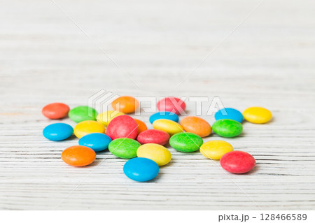 Pile of delicious colorful sweet candies on colored background top view. Confectionery decor Pile of delicious colorful sweet candies on colored background top view. Confectionery decor 128466589