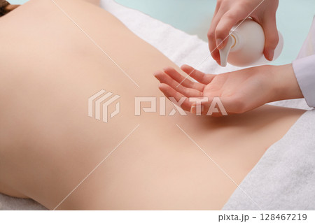 Relaxing spa experience with professional massage in tranquil studio setting 128467219