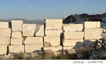Marble quarry sunlight. white large blocks in the rays of sunset.High quality photo 128467792