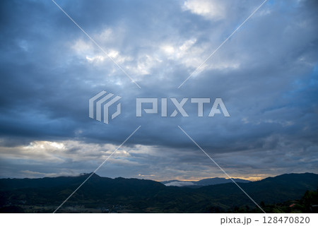 Scenic view dramatic beautiful sunset sky. Natural Sunset Sunrise on meadow silhouette shadow dark land. Vibrant dramatic sky on sunset, dawn, sunrise in Countryside. Landscape Colorful Sky At Sunset Scenic view dramatic beautiful sunset sky. Natural Sunset Sunrise on meadow silhouette shadow dark land. Vibrant dramatic sky on sunset, dawn, sunrise in Countryside. Landscape Colorful Sky At Sunset 128470820