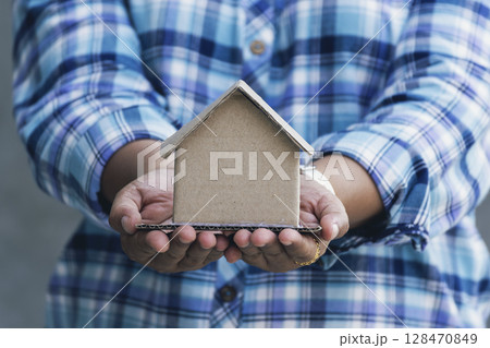 Real estate agent hands holding home business mortgage loan investment property. Hands saving protection home residential concepts. Insurance Agent sale residence ownership household protection care Real estate agent hands holding home business mortgage loan investment property. Hands saving protection home residential concepts. Insurance Agent sale residence ownership household protection care 128470849