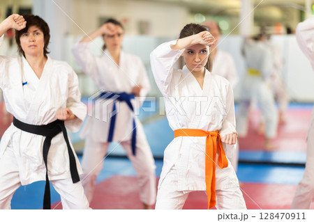 Women in a white kimono in training on a map 128470911