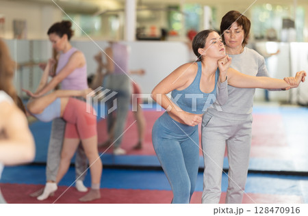 Women practice self-defense techniques in pairs Women practice self-defense techniques in pairs 128470916