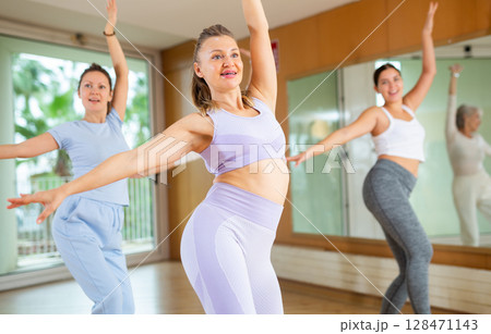Active middle-aged woman practicing oriental dance Active middle-aged woman practicing oriental dance 128471143