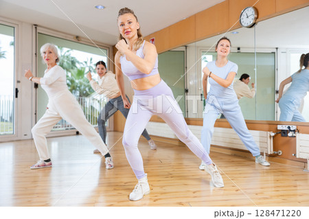 Group of women training sport dance in modern studio 128471220