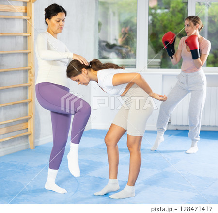 Two young women training self-defense techniques 128471417