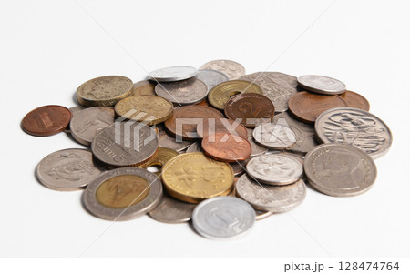 Pile of old coins isolated on white, blurry background. 128474764