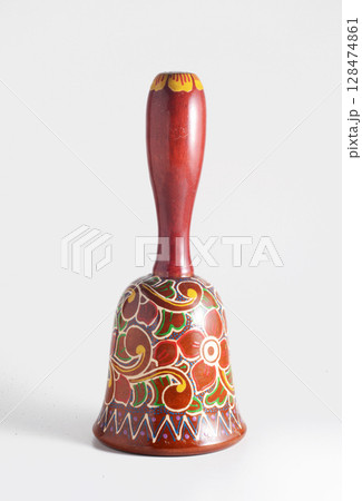 Decorative hand painted wooden hand bell. Decorative hand painted wooden hand bell. 128474861
