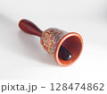 Decorative hand painted wooden hand bell. 128474862