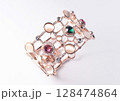 Bracelet with colorful crystals caged in rose-colored plated metal alloy. 128474864