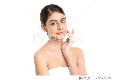 A beautiful young Asian woman with clean, fresh skin against a white background. Skincare, facial treatment, cosmetology, beauty, and spa. An elegant portrait of an Asian woman. A beautiful young Asian woman with clean, fresh skin against a white background. Skincare, facial treatment, cosmetology, beauty, and spa. An elegant portrait of an Asian woman. 128475209