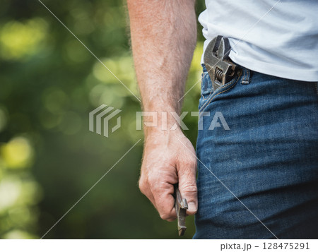Attractive man, hand tools and work clothes 128475291