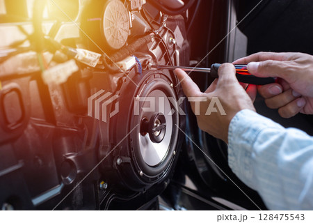 Technician installing the car speaker 128475543