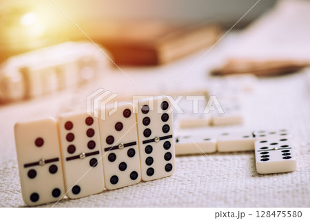 Playing Dominoes on the table 128475580