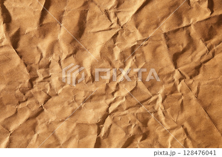 Brown crumpled paper material texture Brown crumpled paper material texture 128476041