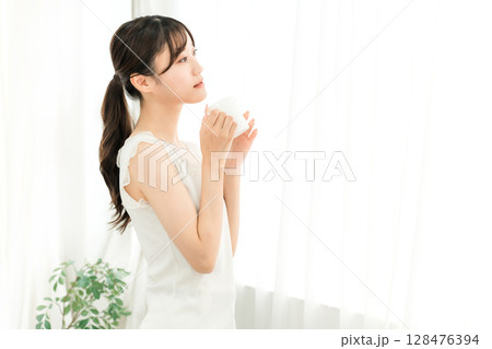 朝、家で白湯・コーヒー・ホットドリンク・カフェオレ・カフェラテを飲むリラックスしたアジア人女性 朝、家で白湯・コーヒー・ホットドリンク・カフェオレ・カフェラテを飲むリラックスしたアジア人女性 128476394
