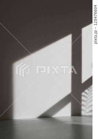 Concrete texture background with shadows from natural light streaming through a window. 128476604