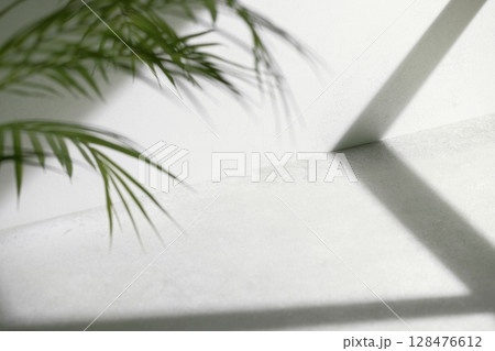 Concrete texture background with shadows from natural light streaming through a window. 128476612