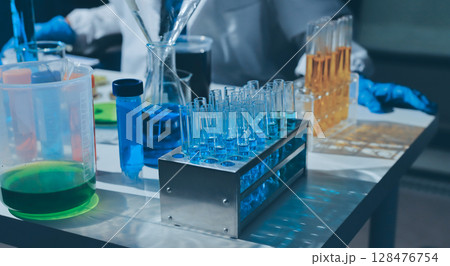 Scientist pipetting medical samples into microplate in laboratory Scientist pipetting medical samples into microplate in laboratory 128476754