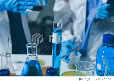 Scientist pipetting medical samples into microplate in laboratory Scientist pipetting medical samples into microplate in laboratory 128476772