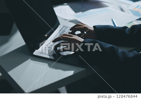 Group of business women working on a financial data expenses document. Group of business women working on a financial data expenses document. 128476844