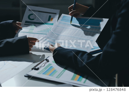 Group of business women working on a financial data expenses document. 128476848