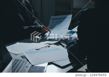 Group of business women working on a financial data expenses document. 128476859