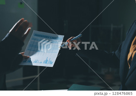 Group of business women working on a financial data expenses document. Group of business women working on a financial data expenses document. 128476865