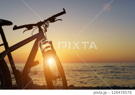 Bicycle by the Seaside at Sunset. Freedom and Tranquility 128478578