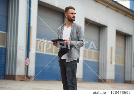 Handsome and young truck driver in casual clothes 128478693