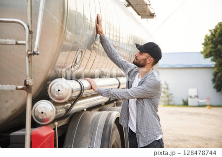 Checking the vehicle condition. Young truck driver in casual clothes 128478744