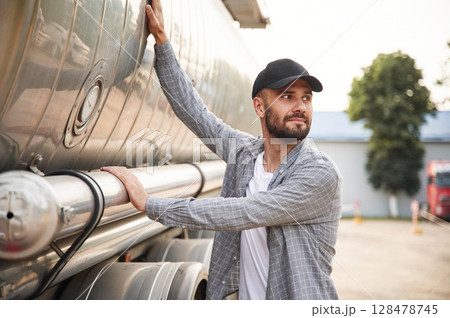 Checking the vehicle condition. Young truck driver in casual clothes 128478745