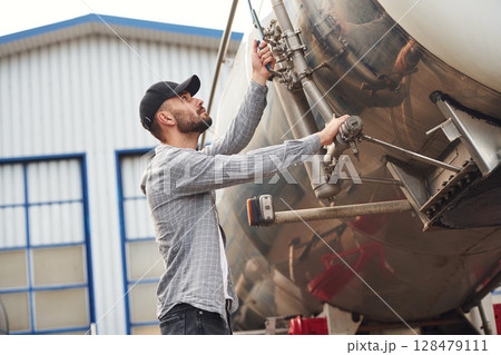 Quality control. Young truck driver in casual clothes 128479111