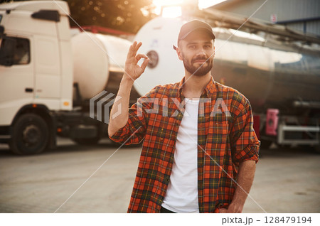 Showing that everything is fine, gesture. Young truck driver in casual clothes Showing that everything is fine, gesture. Young truck driver in casual clothes 128479194