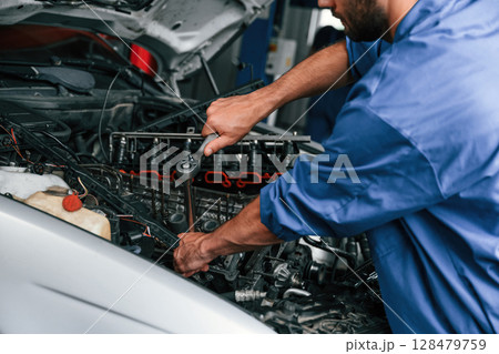 Close up view. Auto mechanic working in garage. Repair service Close up view. Auto mechanic working in garage. Repair service 128479759