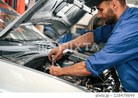 Repair service. Auto mechanic working in garage Repair service. Auto mechanic working in garage 128479849
