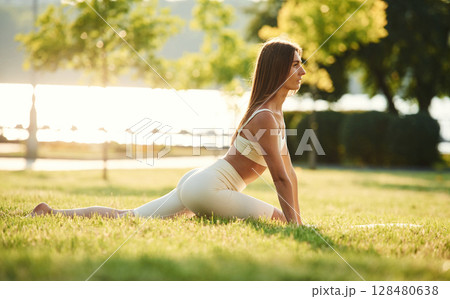 In the park at sunny daytime. Beautiful young woman in sportive clothes In the park at sunny daytime. Beautiful young woman in sportive clothes 128480638