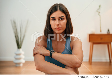 Portrait of beautiful woman that is in blue, sitting indoors Portrait of beautiful woman that is in blue, sitting indoors 128482625