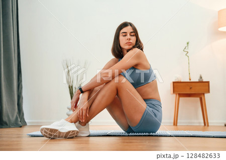 Pretty woman in sportive clothes have fitness day indoors Pretty woman in sportive clothes have fitness day indoors 128482633