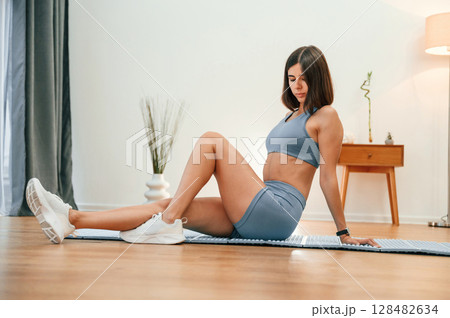 Pretty woman in sportive clothes have fitness day indoors Pretty woman in sportive clothes have fitness day indoors 128482634