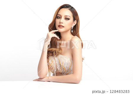 A beautiful young Asian woman with clean, fresh skin against a white background. Skincare, facial treatment, cosmetology, beauty, and spa. An elegant portrait of an Asian woman. 128483283