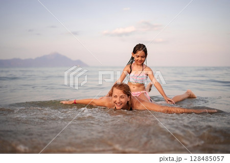 Joyful moments between a mother and daughter at the seaside Joyful moments between a mother and daughter at the seaside 128485057