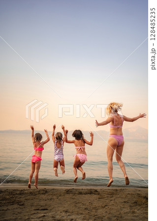 Joyful family moments at the beach during a sunny afternoon Joyful family moments at the beach during a sunny afternoon 128485235